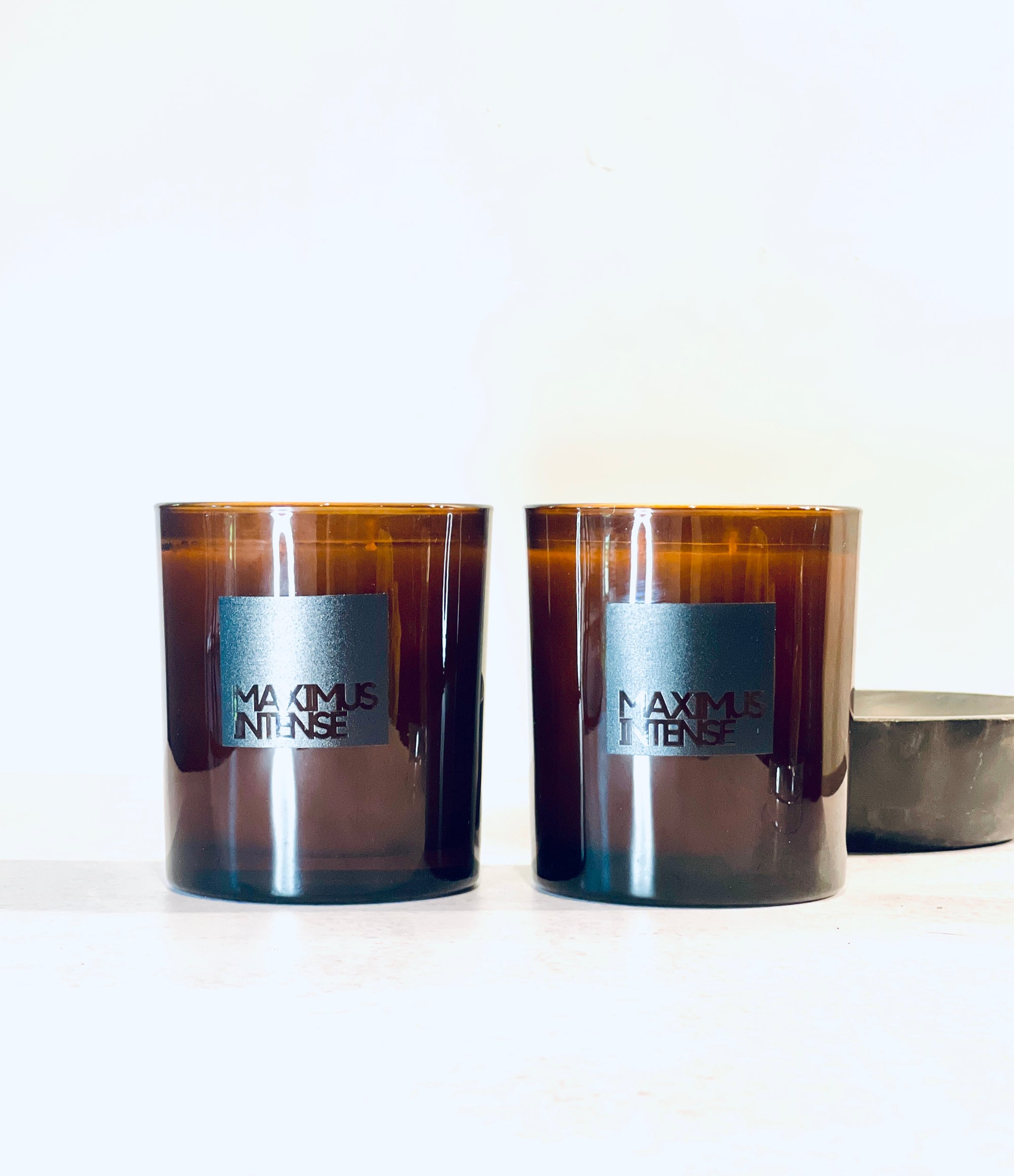 Close-up of Maximus Intense candle with earthy layers of Italian bergamot and cedar