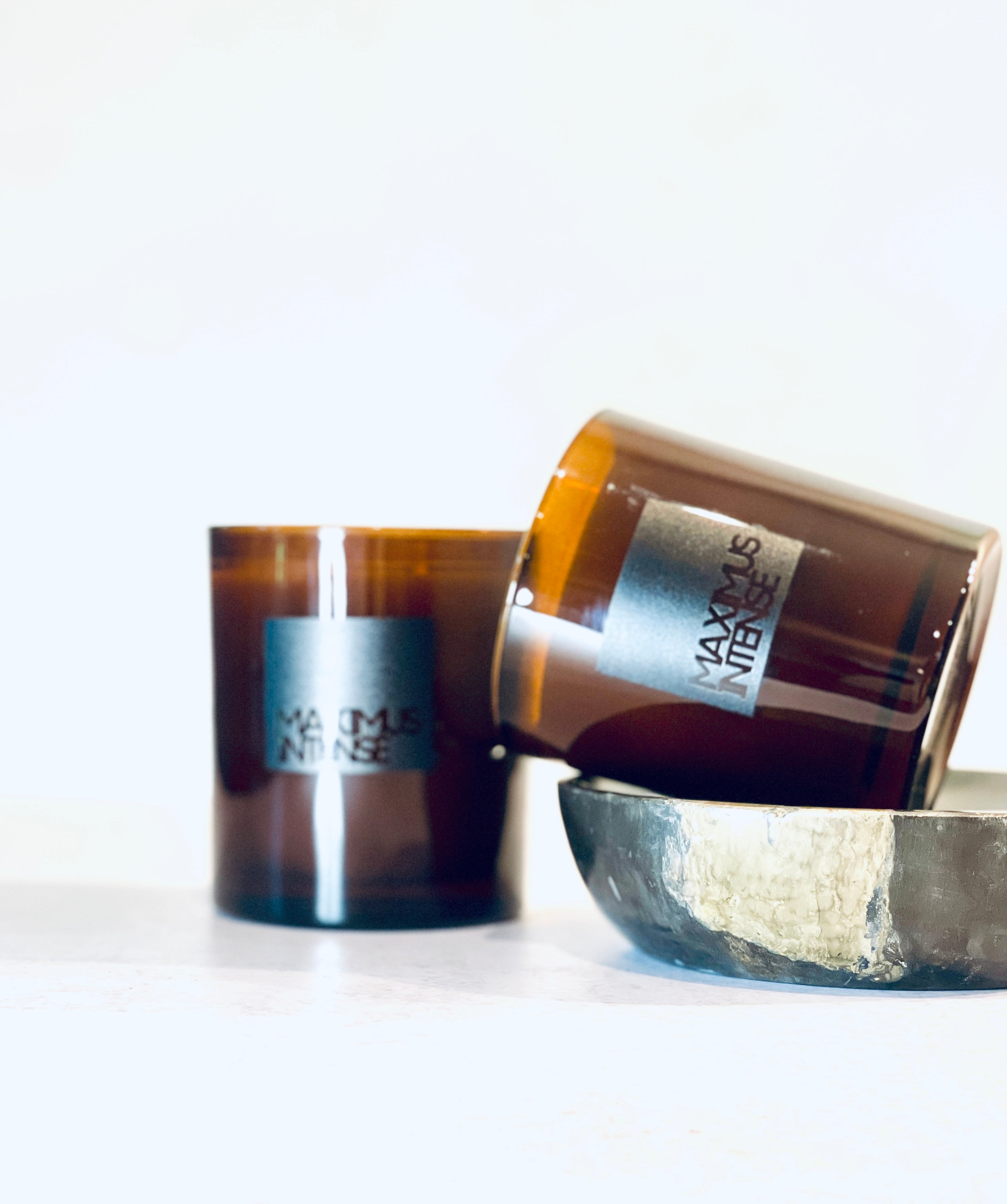 Maximus Intense candle in glossy amber glass tumbler, showcasing its refined masculine scent