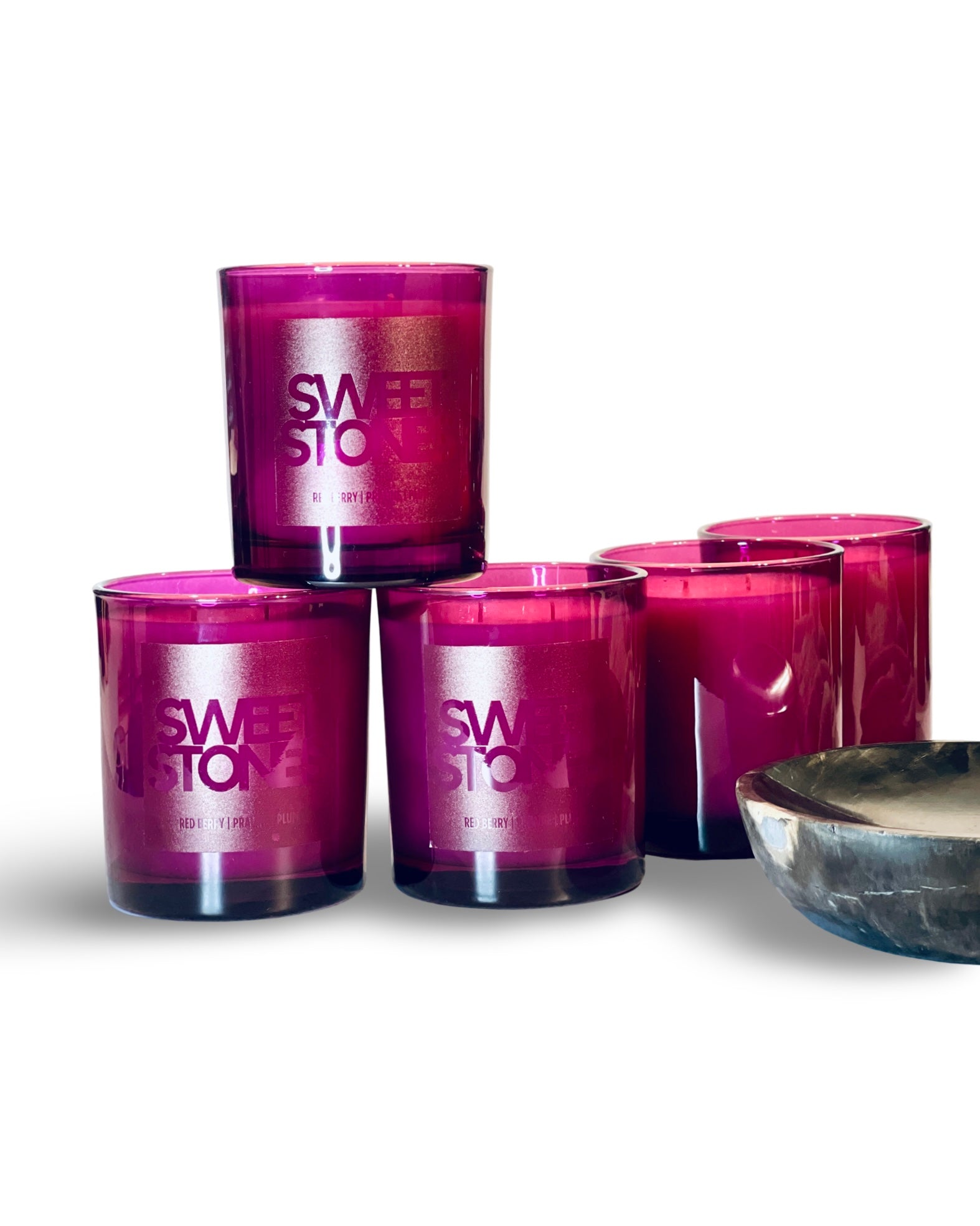 Sweet Stones candle in glossy plum glass tumbler, showcasing a fruity and gourmand fragrance